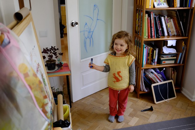 Child Drawing on Glass with Washable Crayons