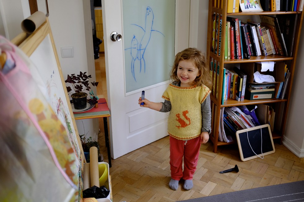 Child Drawing on Glass with Washable Crayons