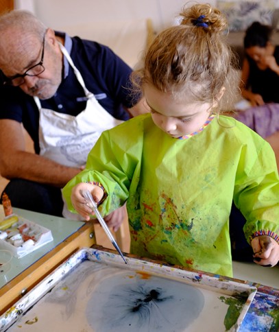 Child using Marbling Ink Kit for Japanese Suminagashi and Dropper wearing IKEA MÅLA Art Smock