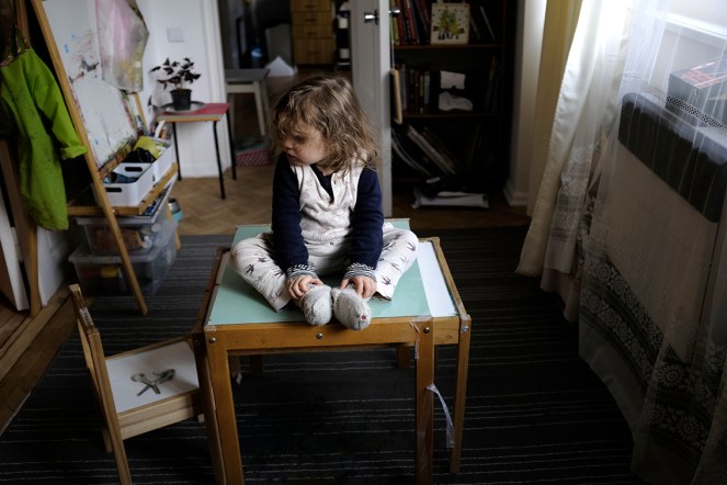 child sitting on table feet together IKEA easel table chairs
