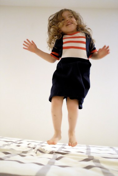 kid jumping on bed